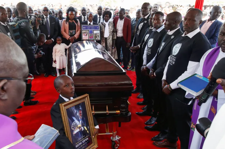 Family members surround the coffin of Kenya's marathon world record holder Kelvin Kiptum, who died in a road accident, during his funeral in Chepkorio on February 23, 2024 [Monicah Mwangi/Reuters]